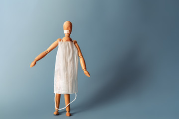 Wooden man in a medical mask.