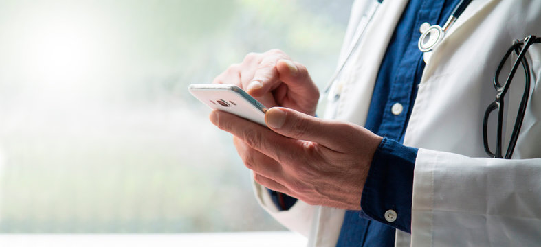 Doctor Using Mobile Phone Close Up View