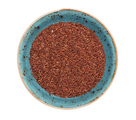 uncooked brown rice in a plate isolated