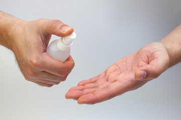 Man's Hand washing hand by alcohol spray. Health care concept and preventing Corona Virus.