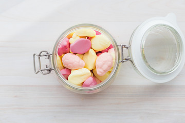 Marshmallows in a glass jar of pink and yellow delicate color. Marshmallows in a glass jar of pink and yellow delicate color.