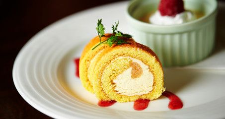 Roll cake with berry sauce