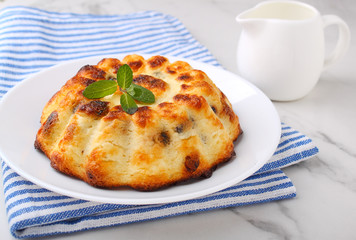 Cottage cheese casserole decorated with mint on a marble background
