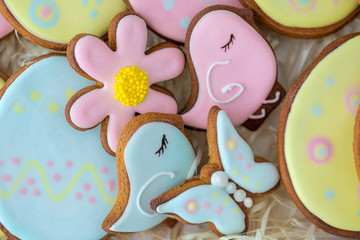 Fototapeta premium Closeup top view flatlay photography of cute holiday colourful Easter cookies laying inside of white gift box.