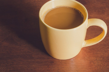 A yellow coffee cup on a wooden surface,Bulgaria, Close-up, Coffee - Drink, Coffee Cup, Cup