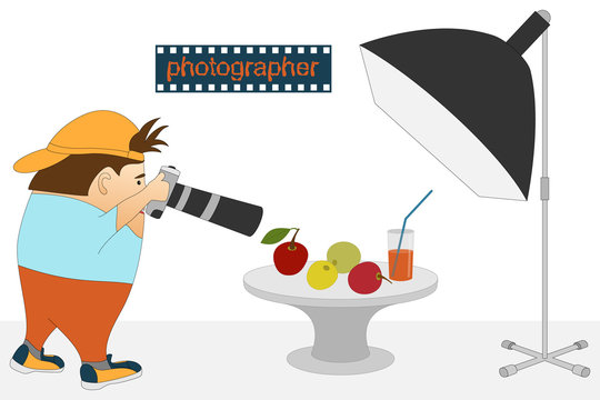 Photographer at work. The process of photographing a still life. Photographic studio with equipment. A sign with the text: "photographer". Photosession of food - apples and a glass with juice.