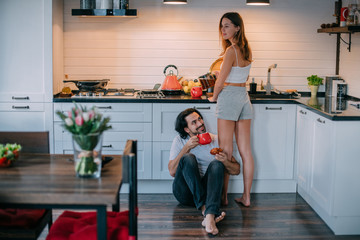 Young loving couple in the morning in the kitchen at home