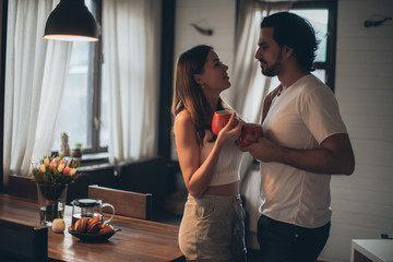 Loving couple in the evening in the living room at home