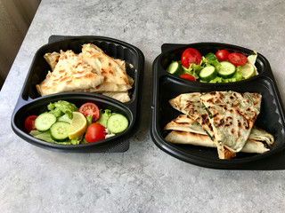 Turkish Take Away Food Gozleme Made with Flat Bread and Salad in Plastic Container Box Plate.