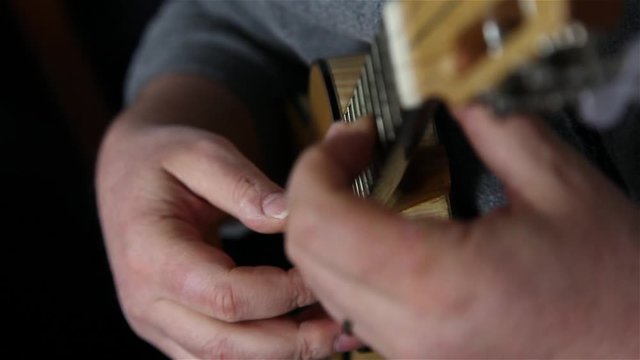 man playing Portuguese ukulele cavaquinho