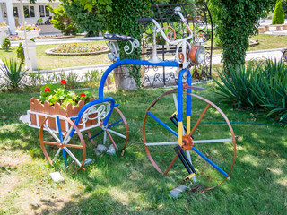Vintage flower bike shaped flower bed with trolley
