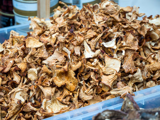 Dried chanterelle mushrooms lie in an open container
