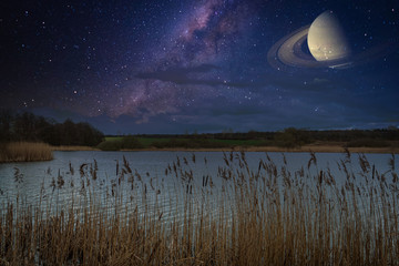 above  lake is the clear starry sky with the Milky Way and Saturn
