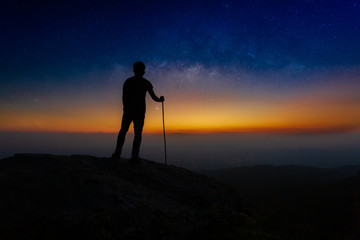 Fototapeta premium Landscape with Milky Way. Night sky with stars and silhouette of a standing happy man on the mountain,Outer Space, Star - Space, Milky Way, Night, Mountain Climbing