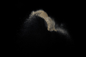 Sandy explosion isolated on black background. Abstract particles cloud. Texture element for design.