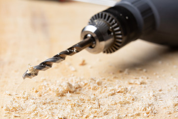 drill perched on a wooden board