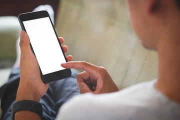 Cropped shot view of man hands holding smart phone with blank copy space screen for your text message or information content, female reading text message on cell telephone during in urban setting.