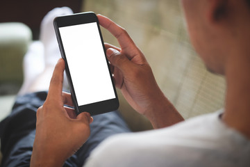 Cropped shot view of man hands holding smart phone with blank copy space screen for your text message or information content, female reading text message on cell telephone during in urban setting.