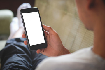 Cropped shot view of man hands holding smart phone with blank copy space screen for your text message or information content, female reading text message on cell telephone during in urban setting.