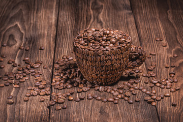 Coffee Cup Table Tree. Natural coffee beans arabica. Horizontal background in brown tones. Cup of coffee wooden table. Full cup of coffee beans wooden table.