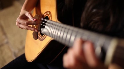 playing twelve steel strings portuguese guitar fado