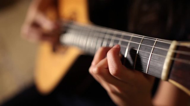 playing twelve steel strings portuguese guitar fado