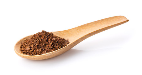 coffee powder in wood spoon on white background