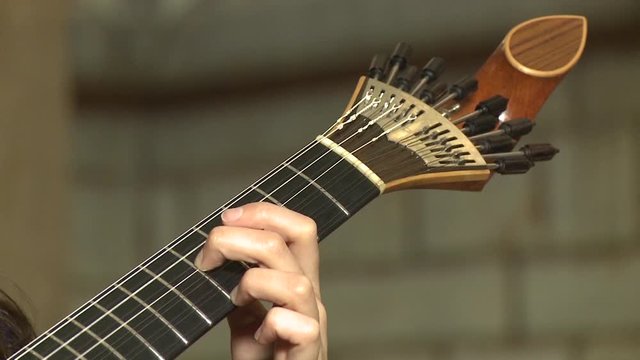 playing twelve steel strings portuguese guitar fado