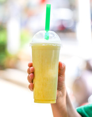 Fresh fruit juice in the hand.