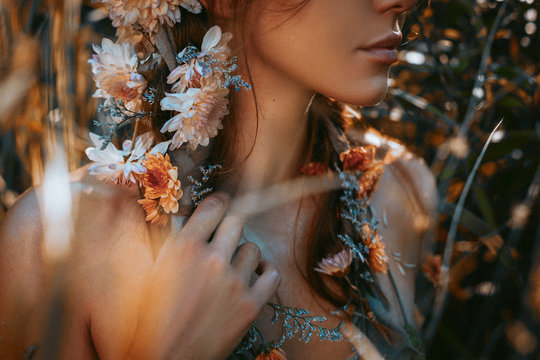 close up portrait of young and tender woman on a feild at sunset