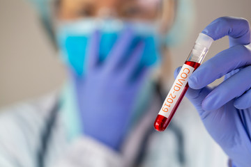 Doctor holding test tube with blood for 2019-nCoV analyzing. covid-19 virus, Coronavirus blood test Concept.