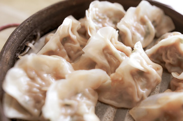 People eat Chinese manti with soy