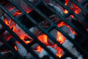 Red-hot coal. BBQ season. Close up of a grill hearth.