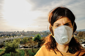 Young woman using mask to protect from virus - virus concept