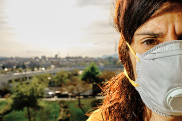 Young woman using mask to protect from virus - virus concept