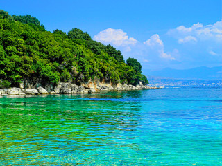 Beautiful beach, turquoise water, trees and sunny sky. Vacations concept.