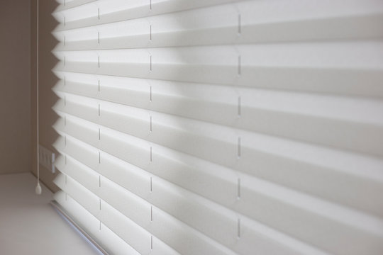 Pleated Shades Size XL, Coulisse, 50mm Fold, Close Up On The Window, White Color, White Background. Modern Pleated Blinds, Luxury Sun Protection And Window Decoration.