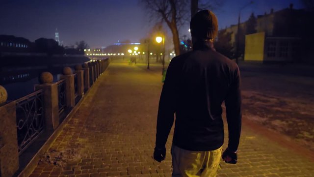 man walking on the street at night