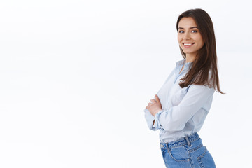 Confident successful businesswoman standing like professional, smiling satisfied, stand in profile near white copy space and turn face to came with knowing determined expression, white background