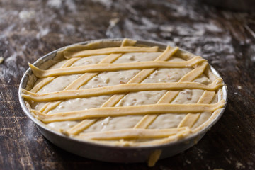 Preparation of Easter cake, also called Pastiera Napoli, typical homemade dessert, with eggs, flour, sugar and vanilla, wheat and colored sugared almonds