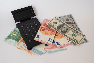 black calculator on money, dollars and euros