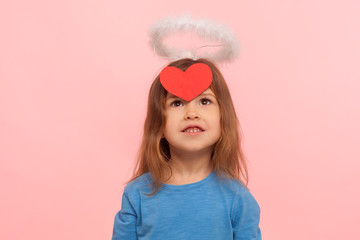 Little cupid angel for Valentines day. Portrait of dreamy adorable preschool girl with nimbus...