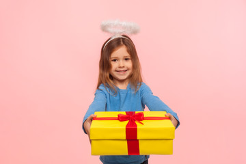 Portrait of generous kind angelic little girl with nimbus giving big birthday present to camera and...