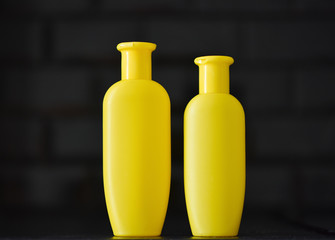 bright yellow plastic bottle on a black background