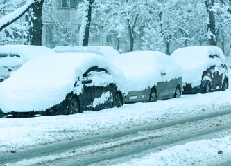 Snowy winter road with cars  in snow storm