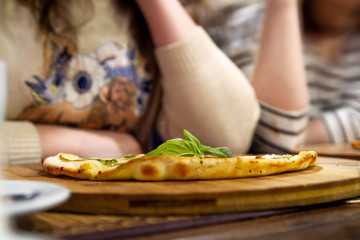 Two girls on a diet sit in a restaurant and do not want to finish the cake. Women get bored eating.