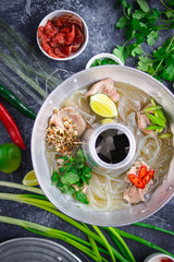 Vietnamese pho bo soup, Asian cuisine, Photo on a dark background