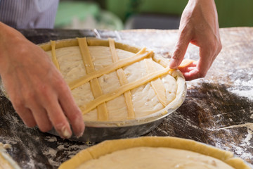 Preparation of Easter cake, also called Pastiera Napoli, typical homemade dessert, with eggs,...