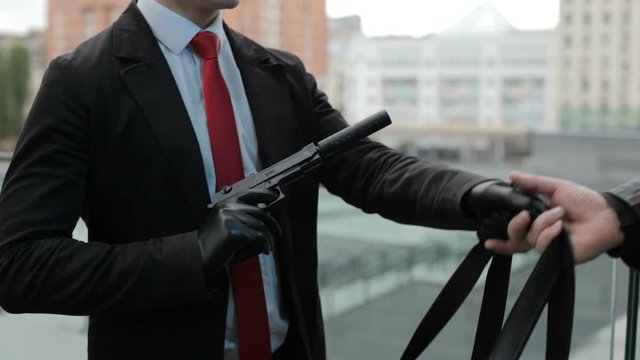The killer moves nervously with a gun in his hand.