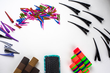 multi colored hair clips in the form of a beak comb and elastic bands on a white background